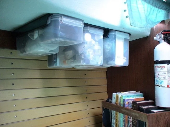 These plastic tubs make sense for a smaller cruiser, keeping things together and easy to access. Great job of organizing stuff.