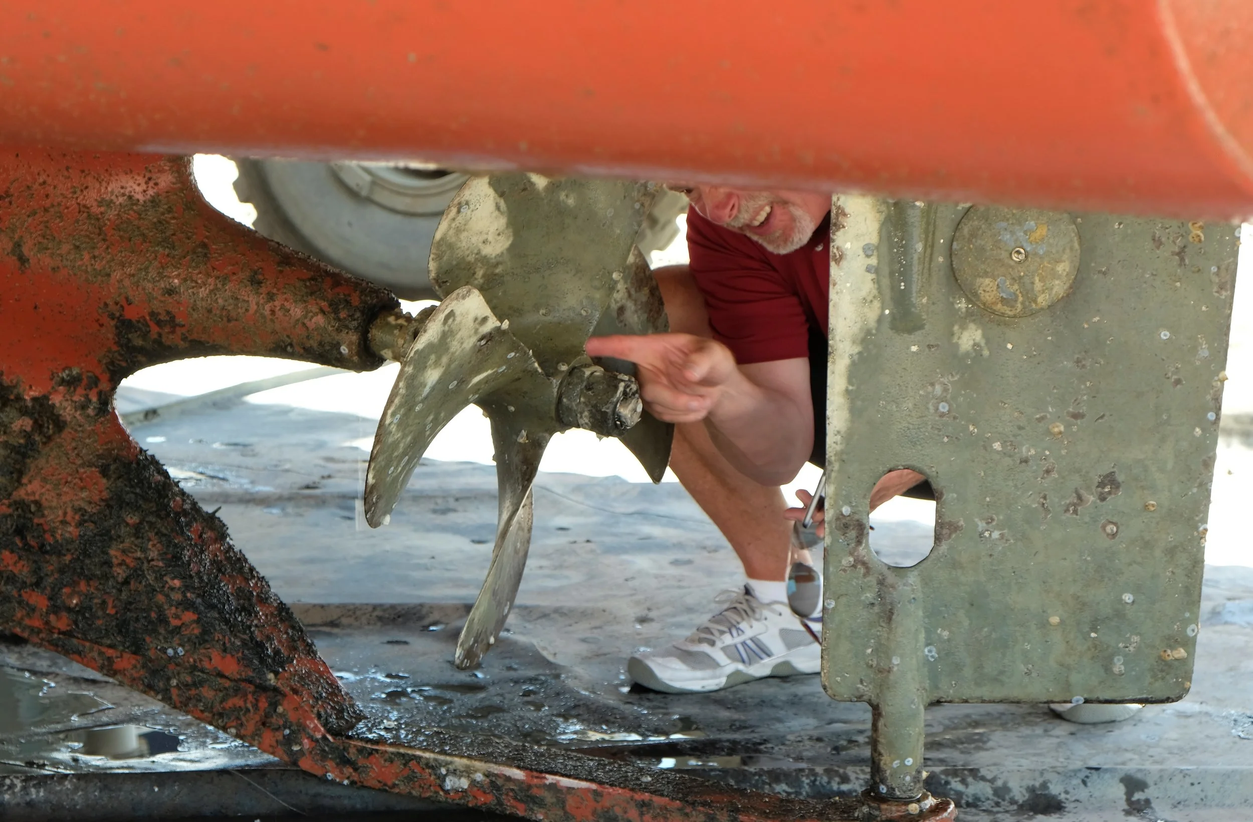 Helmsman Trawlers' Scott Helker inspects the propeller's markings for size and pitch. Note the smaller prop nut is properly installed, ahead of the full prop nut. Nice to see it done right. Now look at the propeller and imagine it begin turning in reverse. In addition to moving the boat backwards, its large blades will claw sideways in the water, pulling the stern in that direction as well. That is prop walk.
