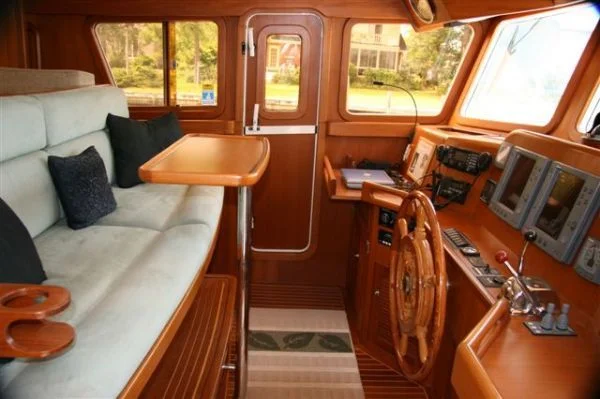 This Selene 48 doesn't have the room in the pilothouse for a dedicated helm chair, but the settee is comfortable and close to the controls. The way Brian likes it.