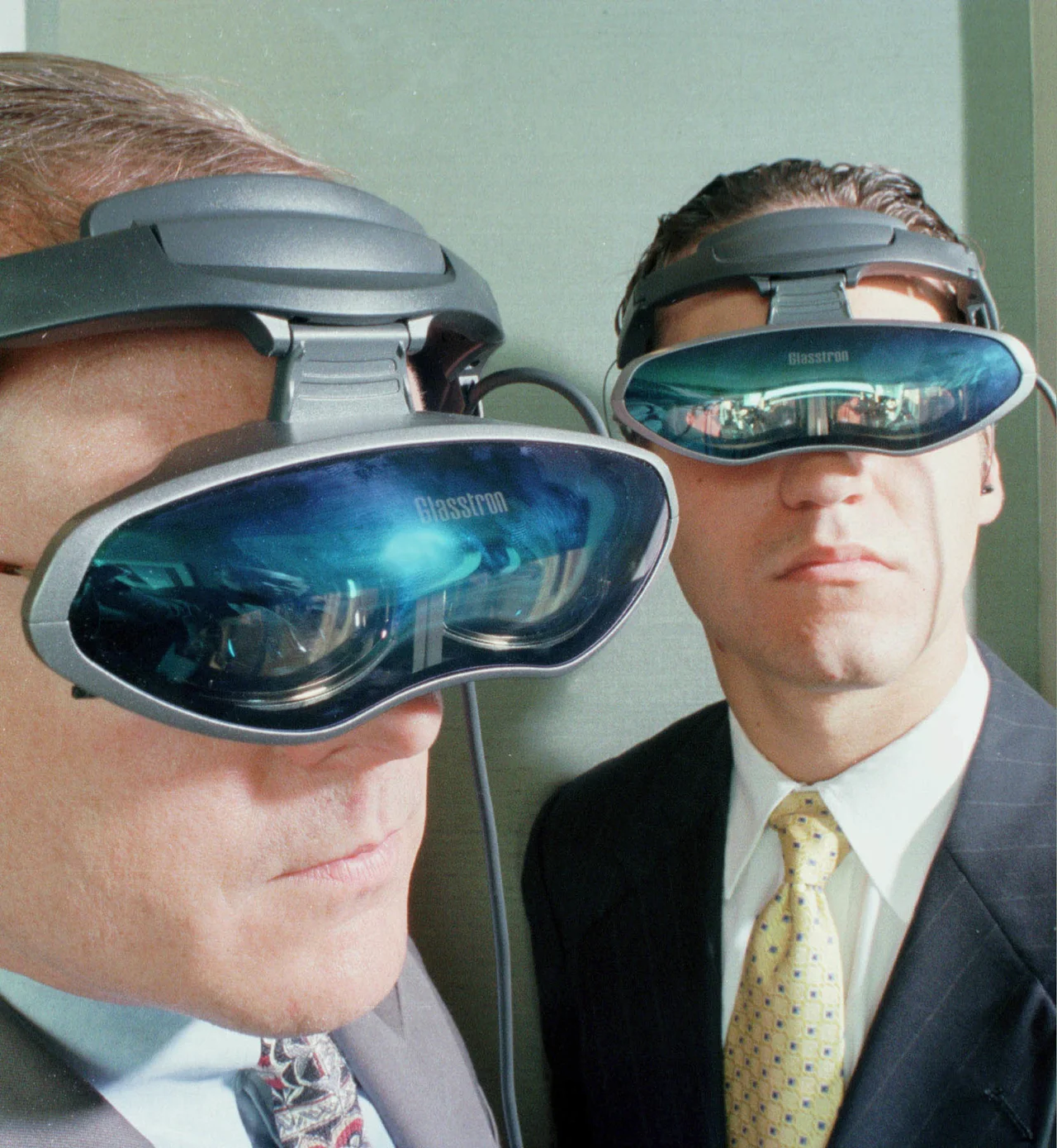 Getty Image: Sony executives Dan Nicholson, left, and Federico Stubbe show off the portable 10-ounce headset that connects to any analog or digital source in New York on July 29, 1998.