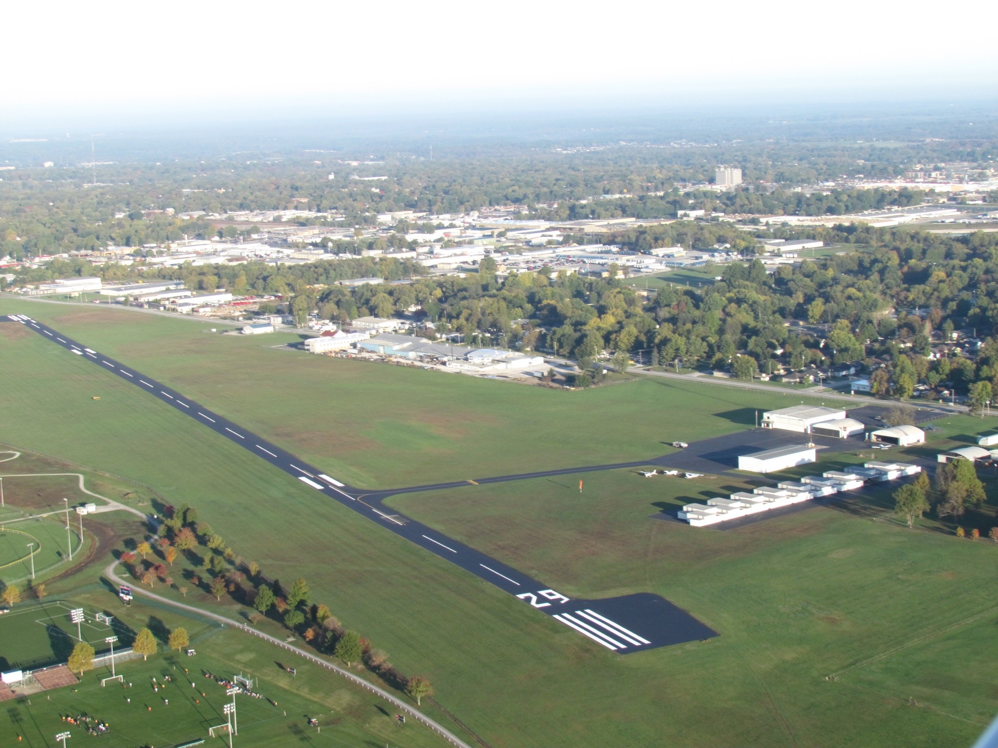 View of a road immediately after sealing, showing the rich black finish and precise white stripes by Springfield Striping and Sealing in Springfield, Missouri.