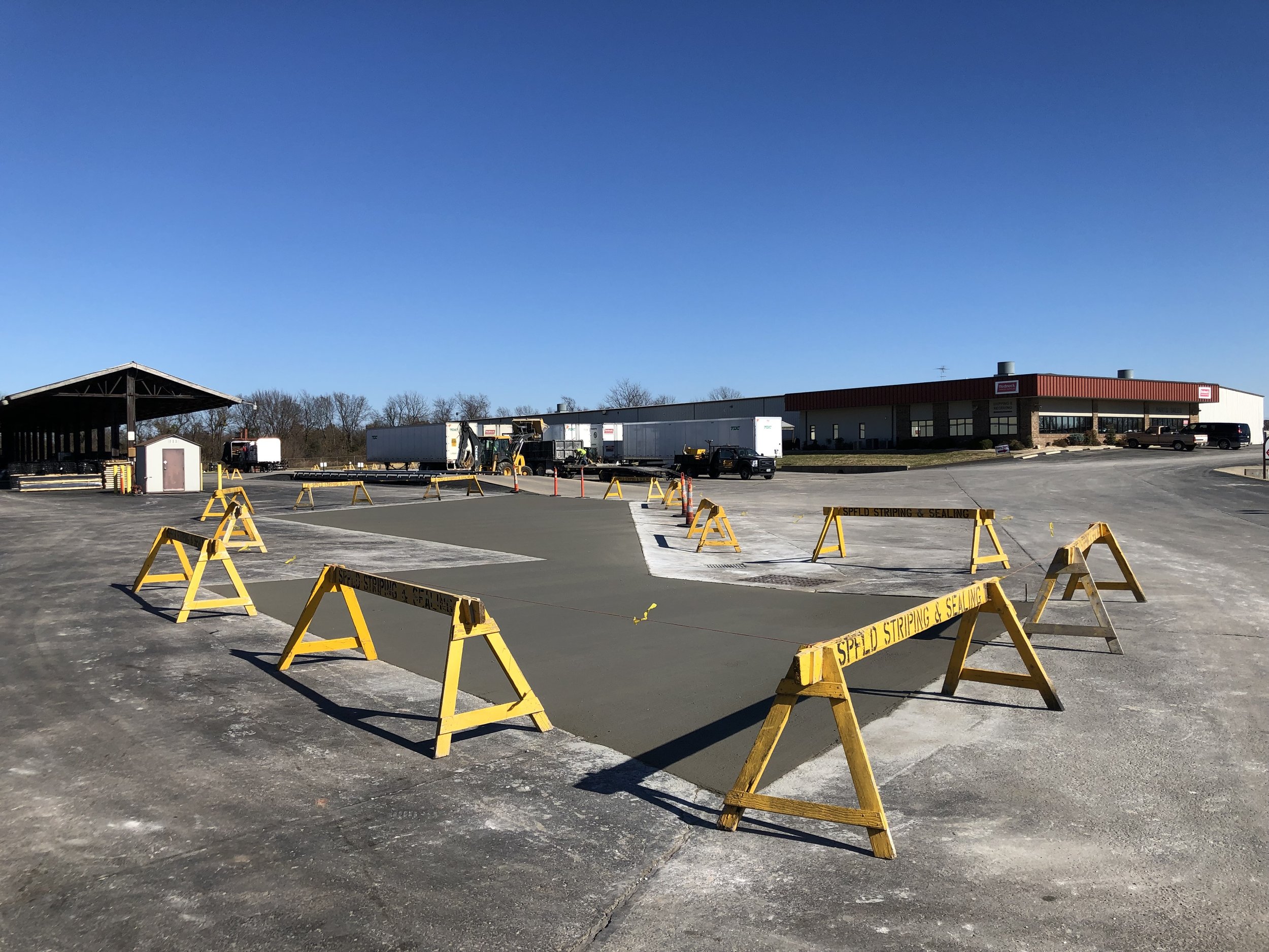 A view of a repair done by Springfield Striping and Sealing to promote proper drainage and prevent puddles in a parking lot near Springfield MO.