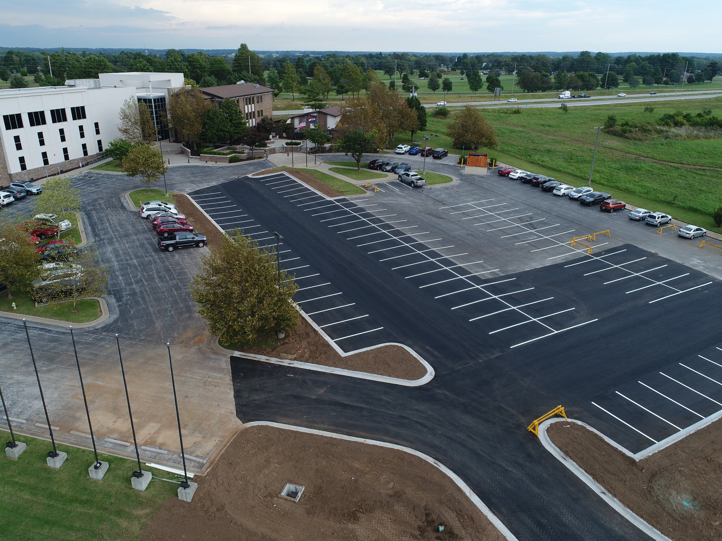 Aerial view of a newly completed parking lot sealing and striping near Springfield, MO, showcasing the precision of striping jobs and the quality asphalt sealing.