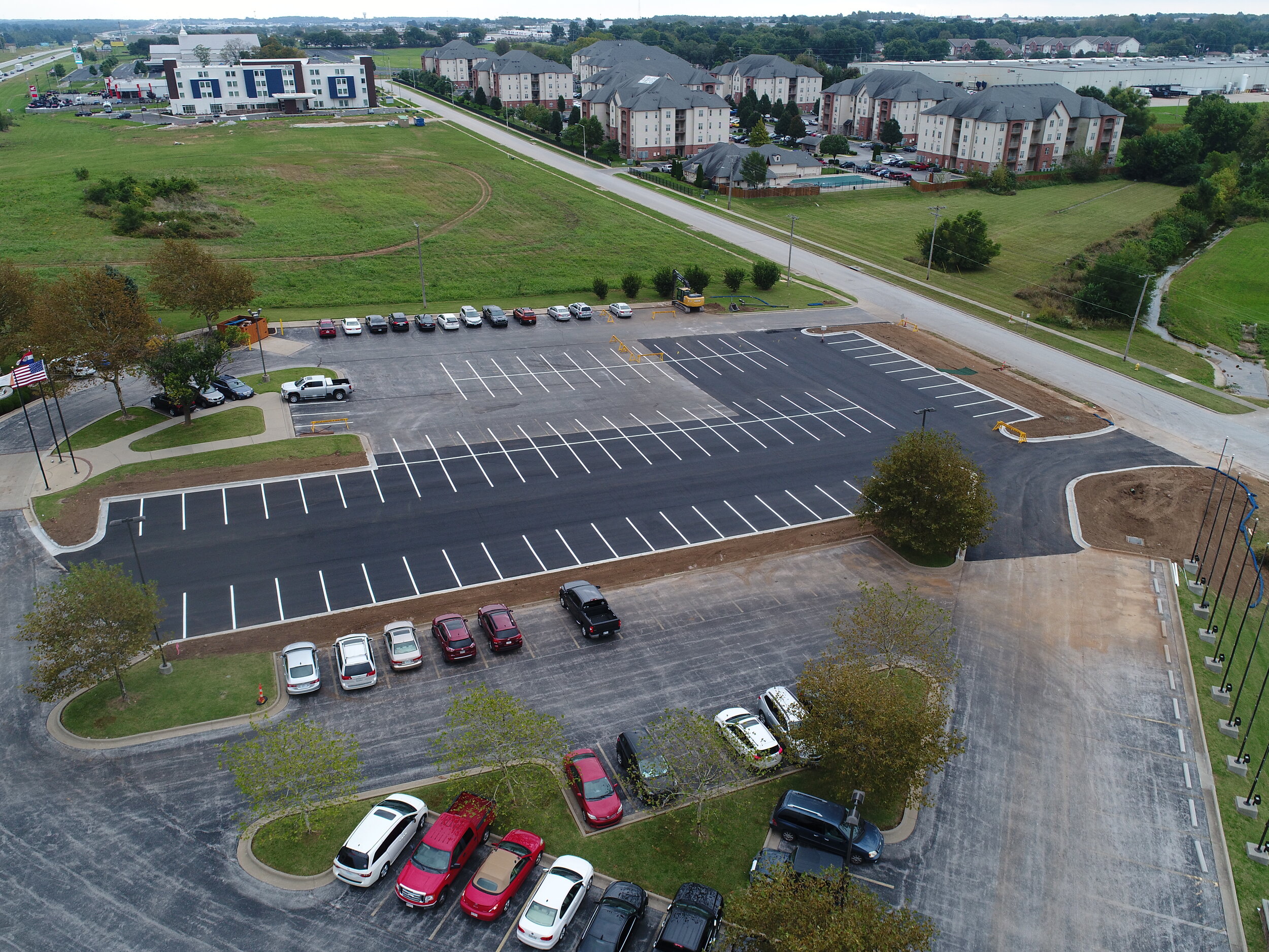 Aerial view of a large parking lot with newly applied seal coating and striping by Springfield Striping &amp; Sealing in Springfield, Missouri.