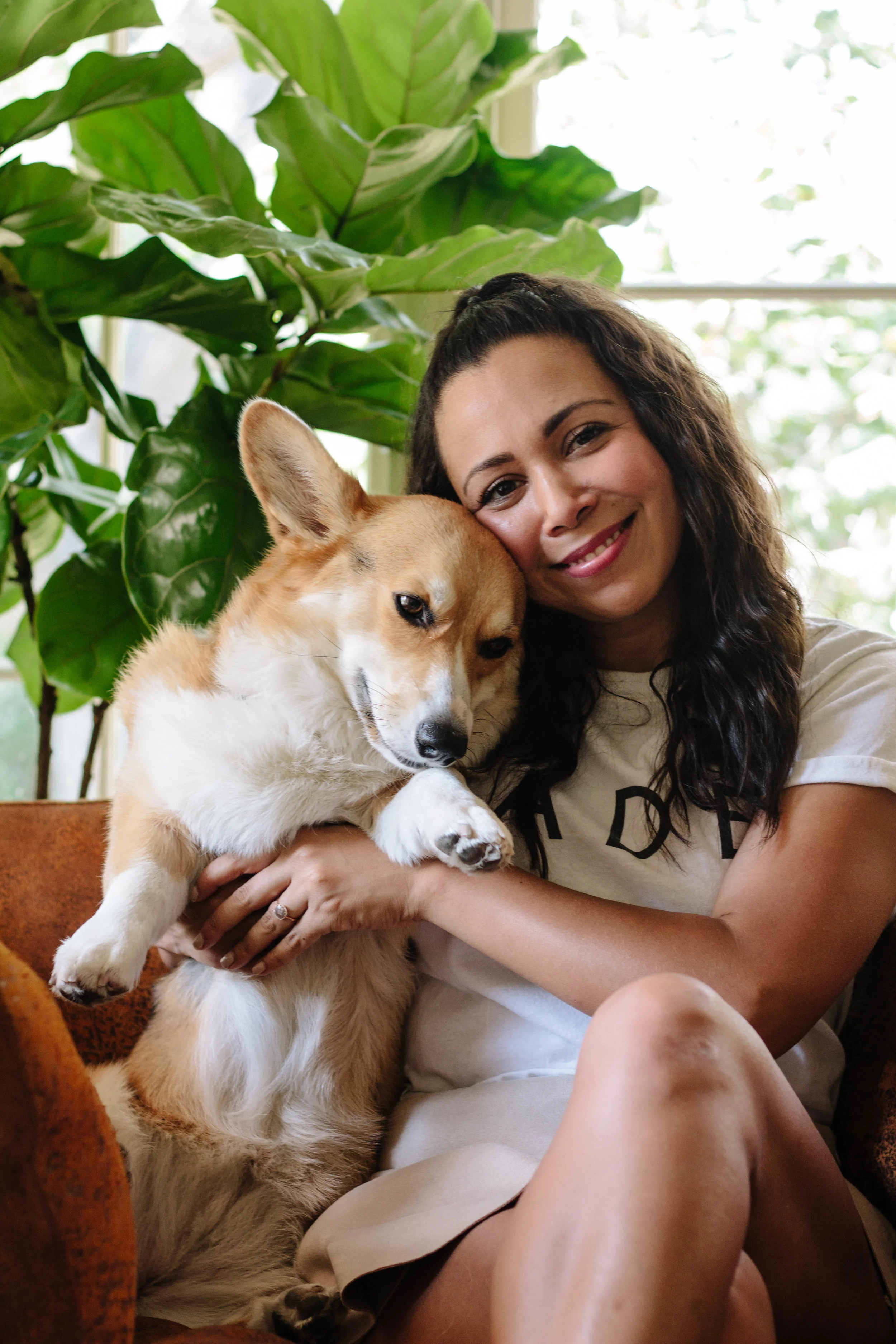 Adrianna Adarme in her home with her corgi Amelia.