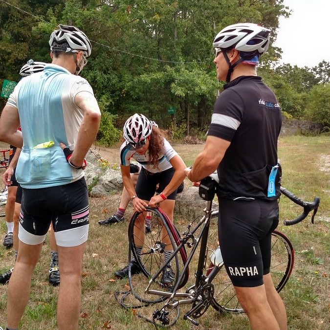 Fixing a flat on a group ride. Photo by Ted M.