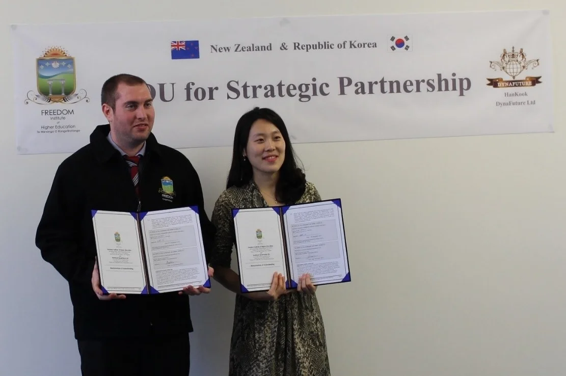 Rachel, S. YOO, the President of HanKook DynaFuture and Eliot Henderson a Director of FREEDOM hold copies of the new MOU