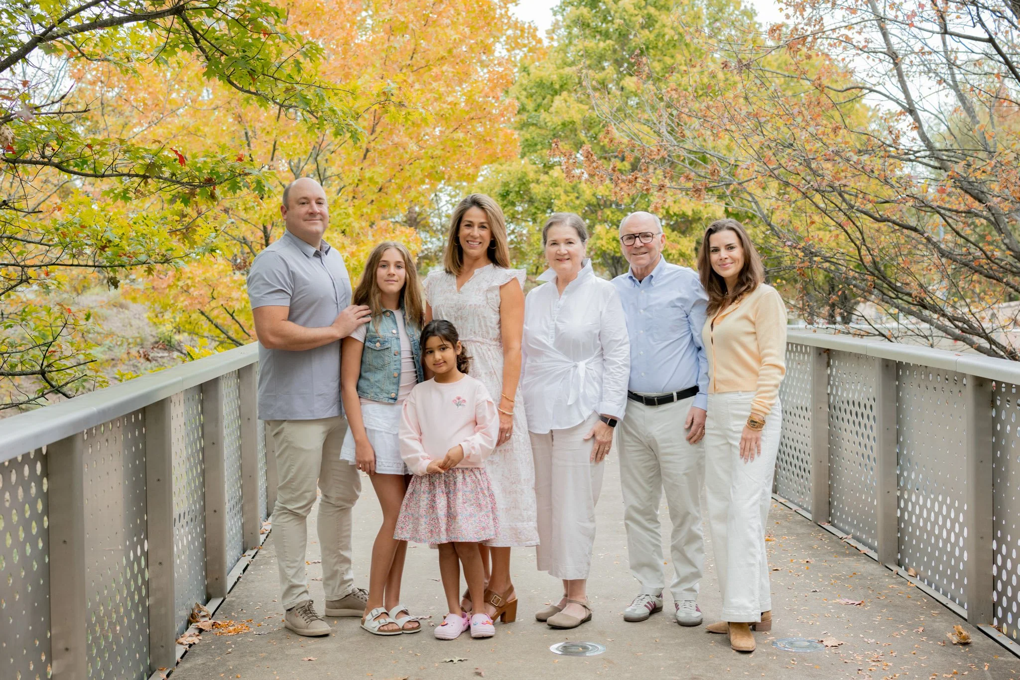 Extended family session in Nashville on a bridge with fall foliage