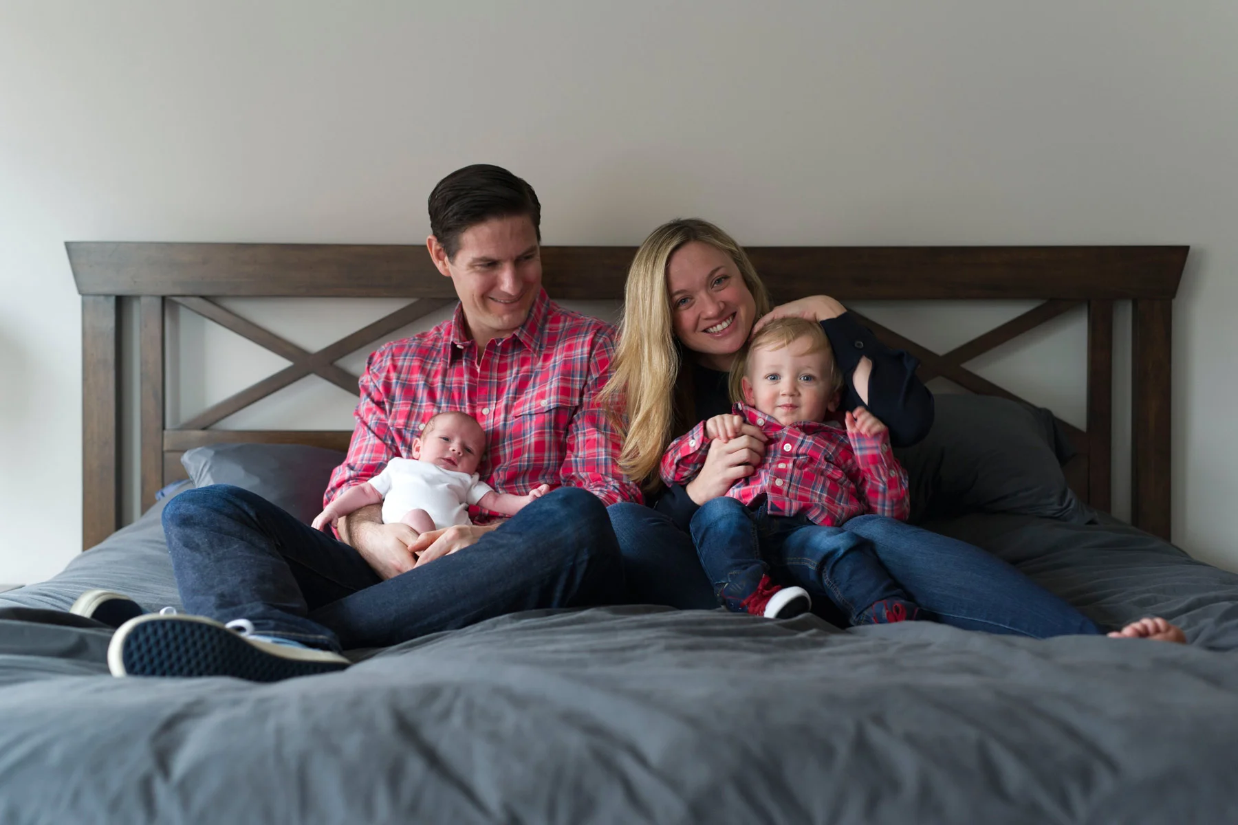 New_family_of_four_on_bed_in_plaid_shirts.jpg