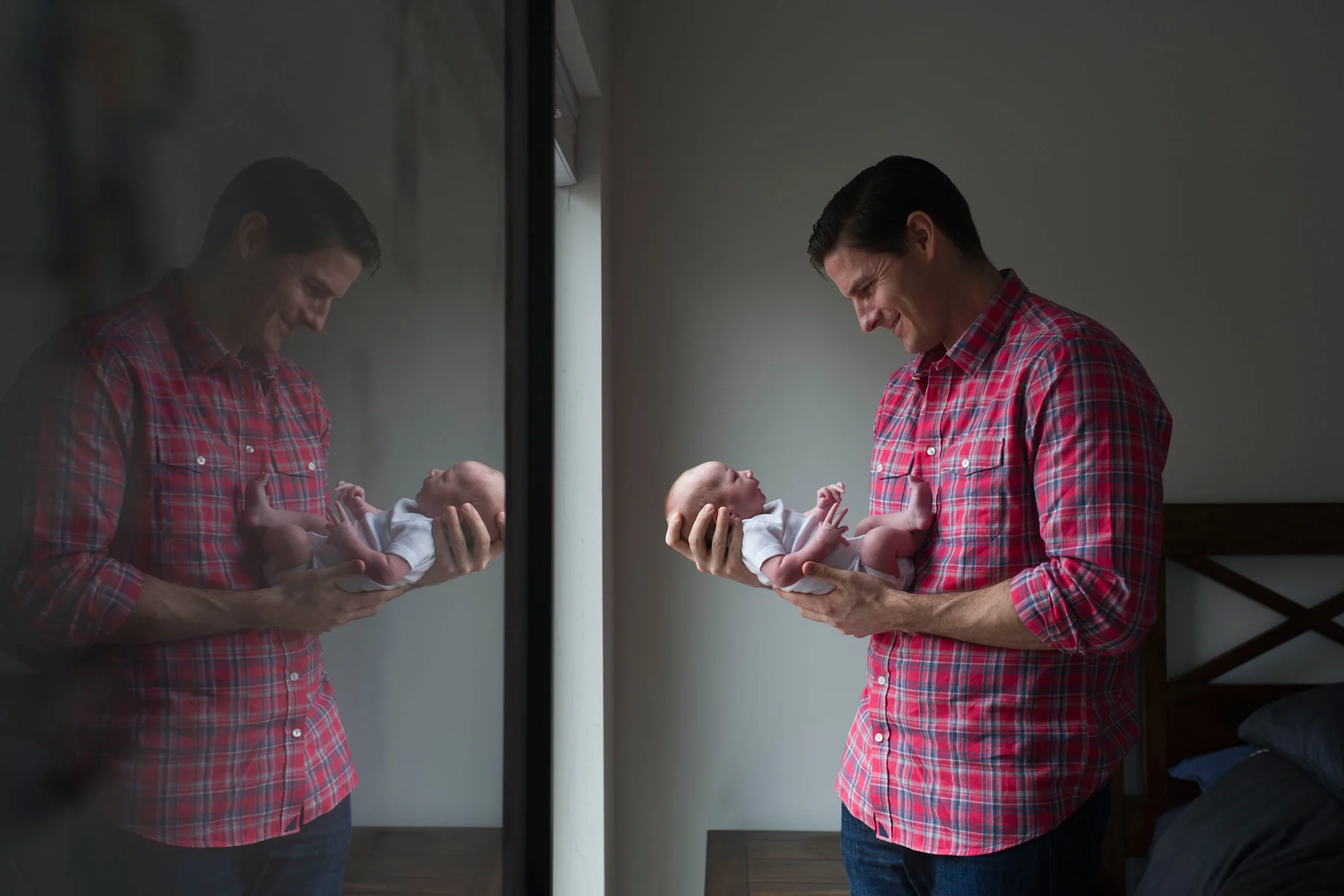 dad_holds_new_son_by_window.jpg