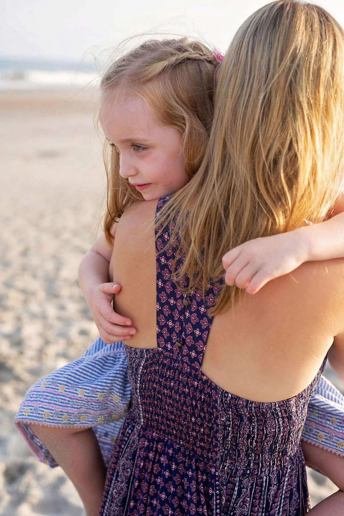 little_girl_clings_to_mother_on_beach_in_ocnj.jpg
