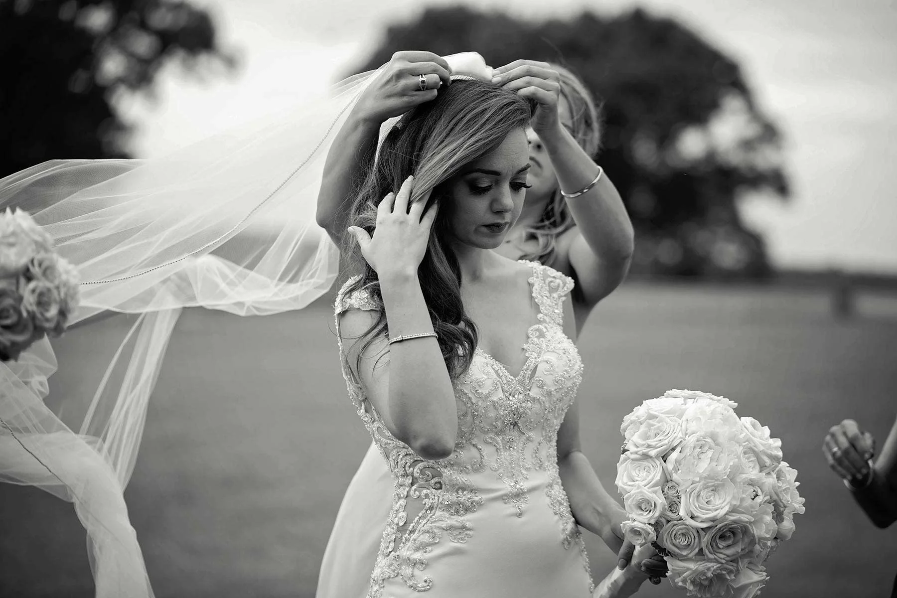 17_Bride_gets_veil_adjusted_by_bridesmaids.jpg
