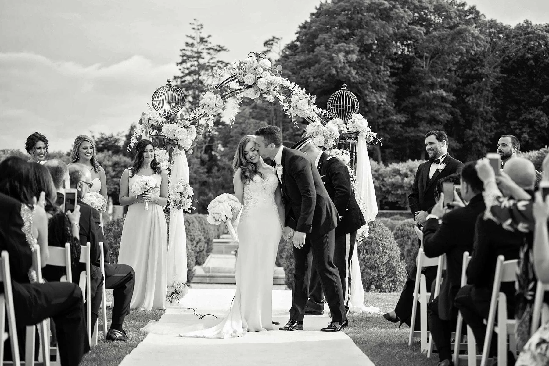 23_groom_kisses_bride_at_altar.jpg