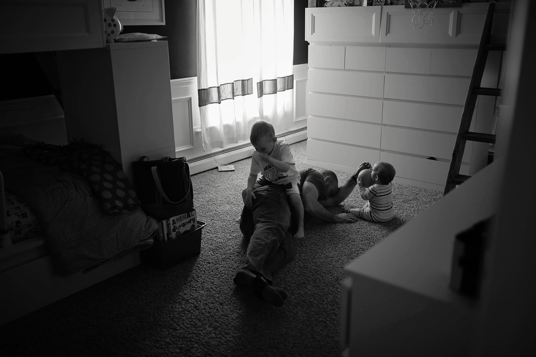 dad with two kids on the floor on Saturday morning