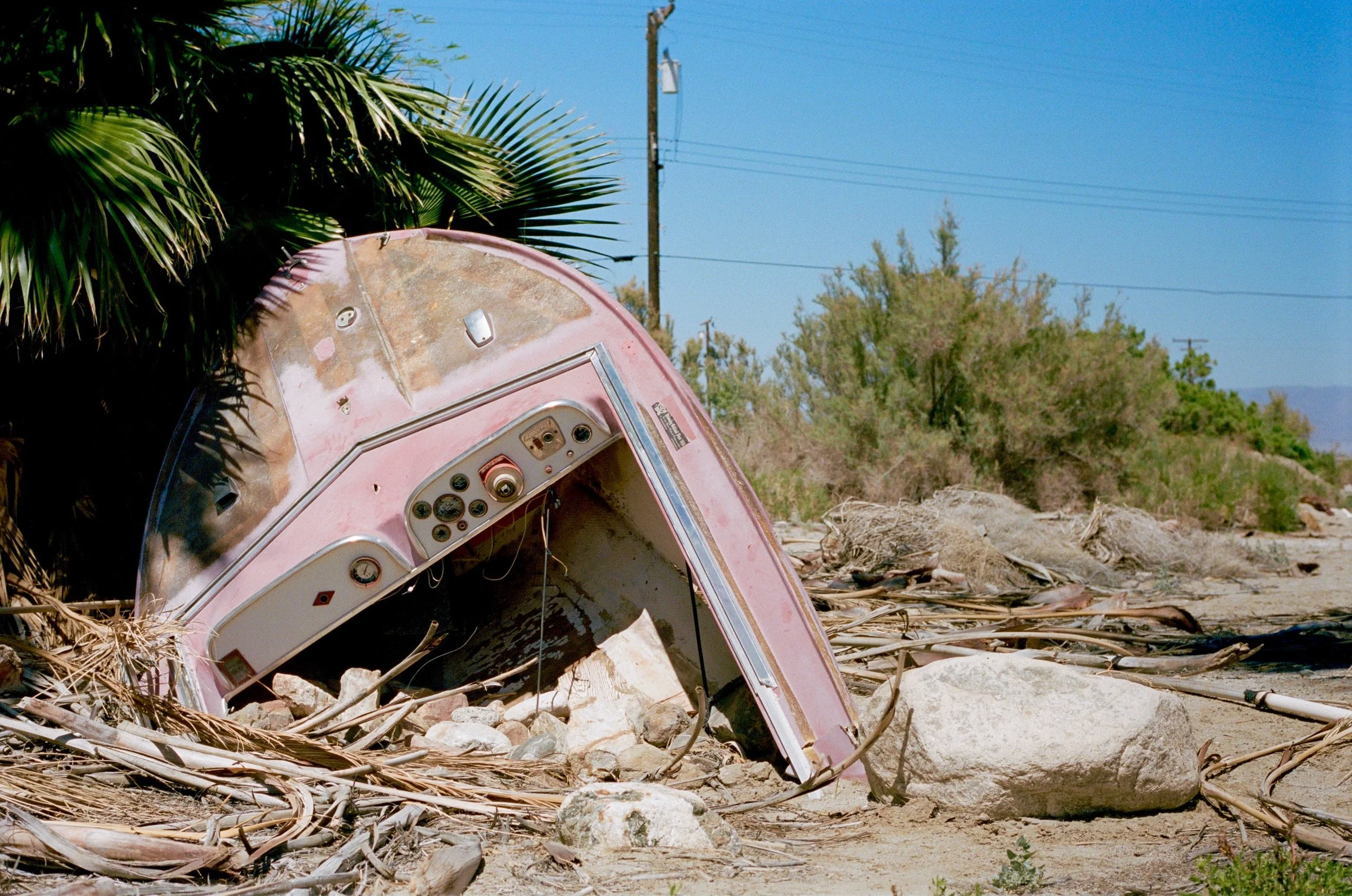 Dilapidated speedboat buried by the side of the road at Salton Sea Beach, Ca., 2017