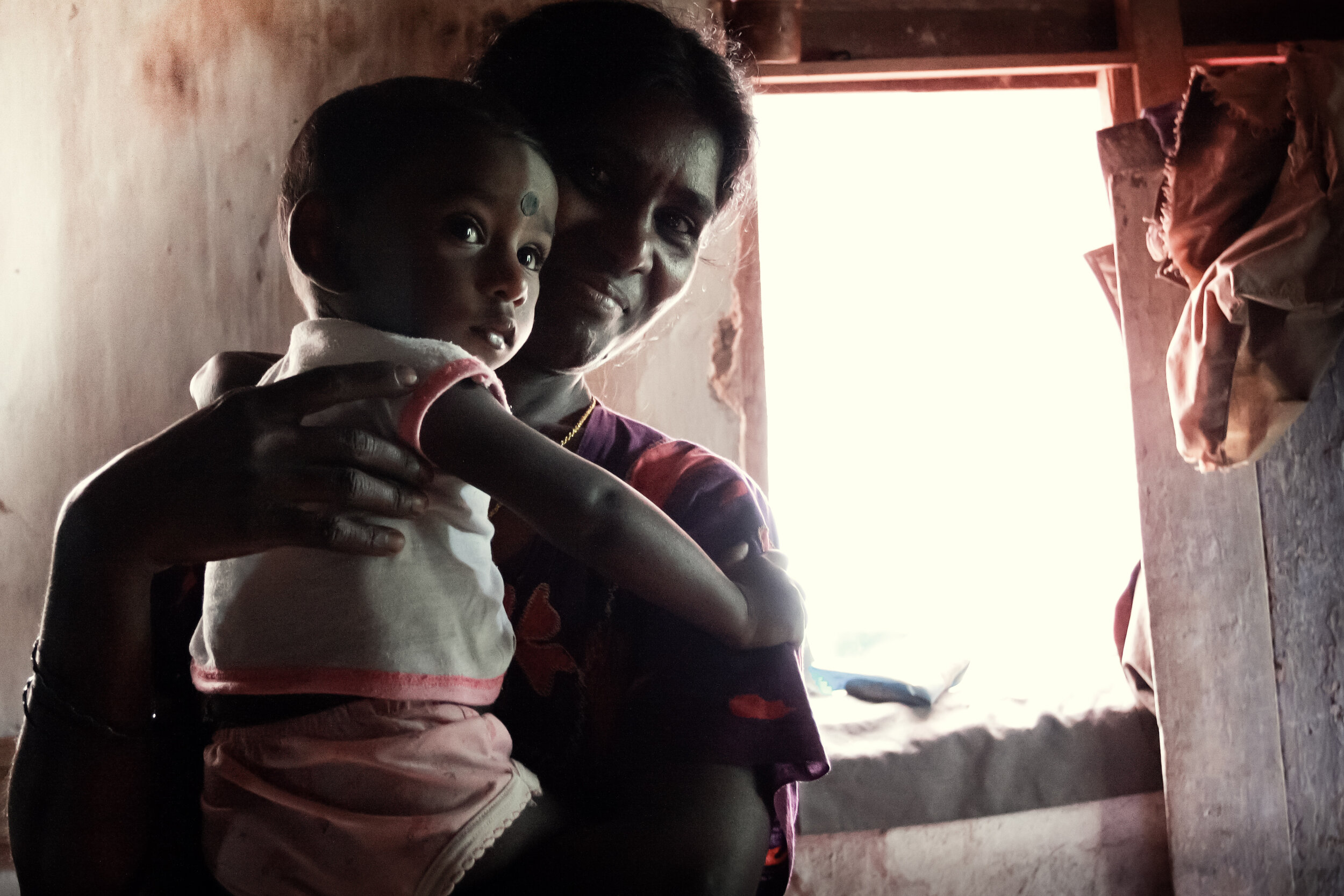  A plantation worker with her infant.   