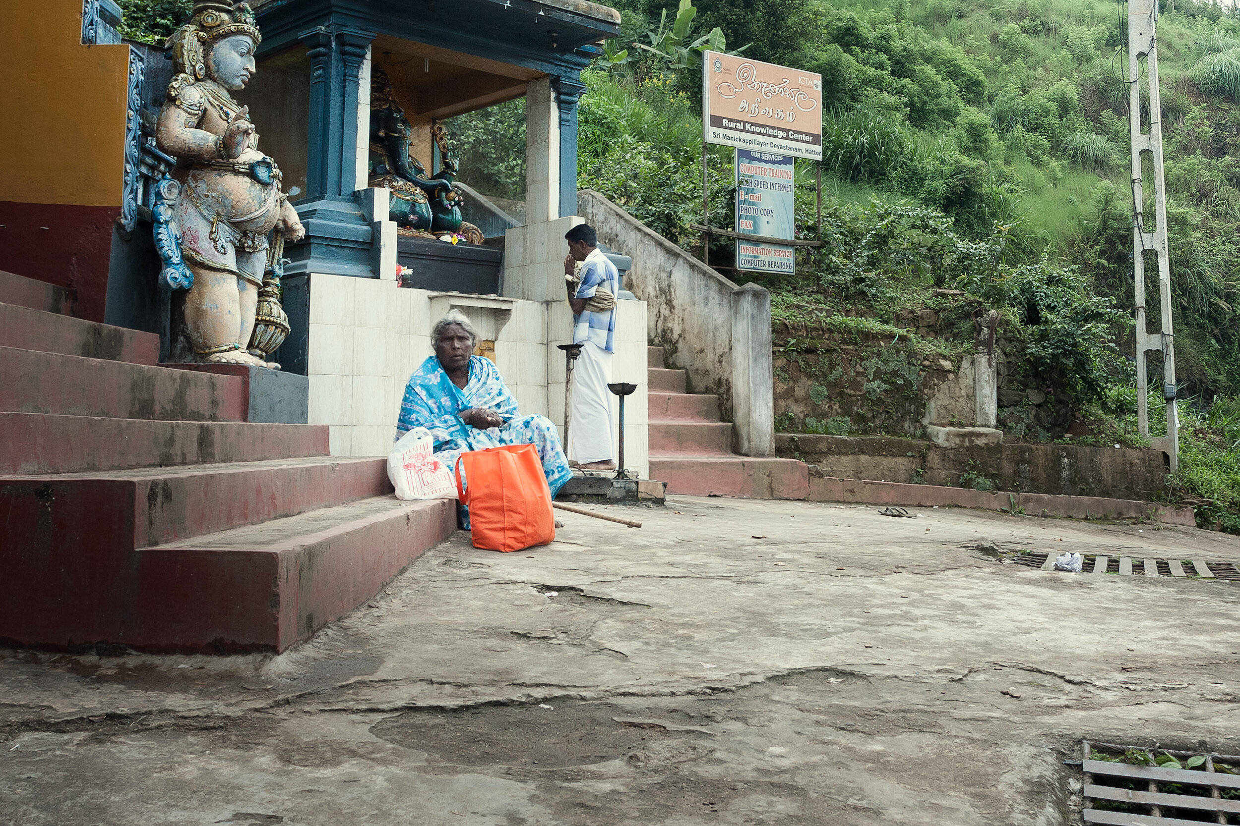  A retired plantation worker begging outside a Hindu temple.  