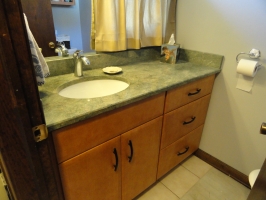 Omega Dynasty - Pennison door style - Butternut stain - Costa Esmeralda Rose Granite