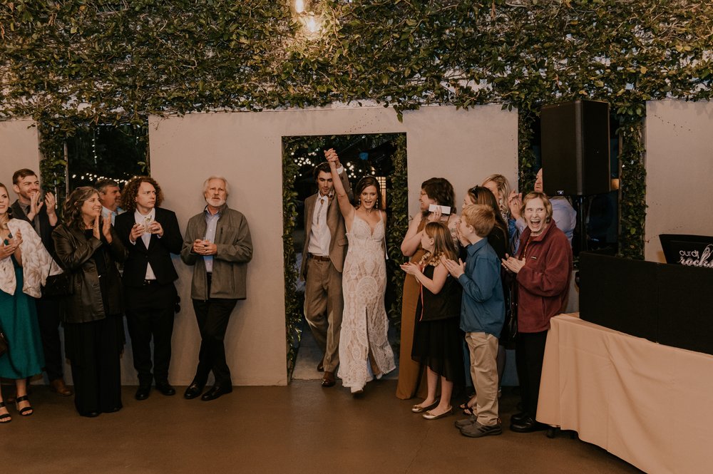  Beautifully captured moment at Robin and Billy's wedding at The Acre, Orlando, showcasing the venue's unique charm and the couple's travel-themed, bohemian style, by professional wedding photographer, Sufia Huq Portraits. 