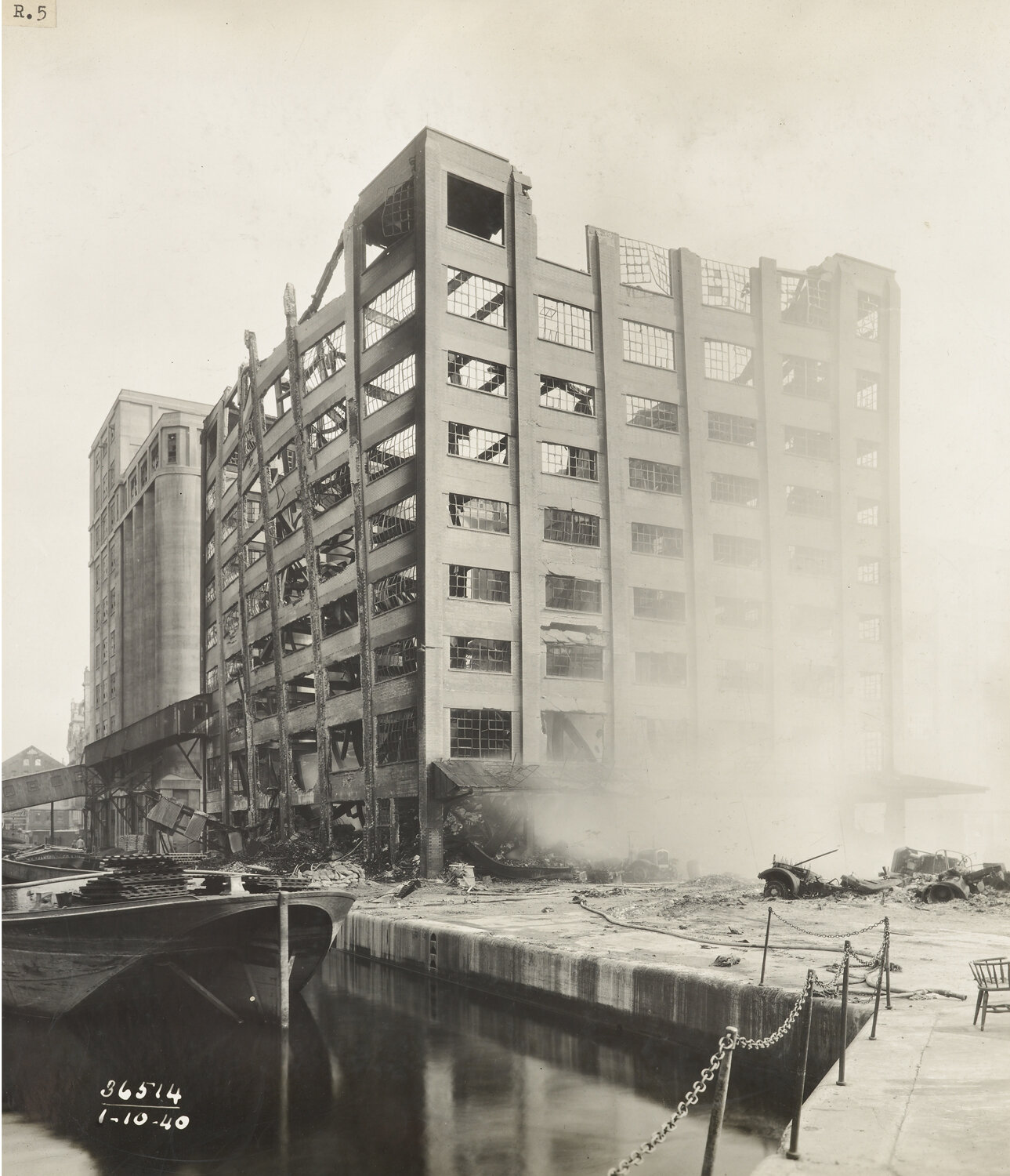 Burnt out store building at Royal Albert Dock after air raid damage, October 1940