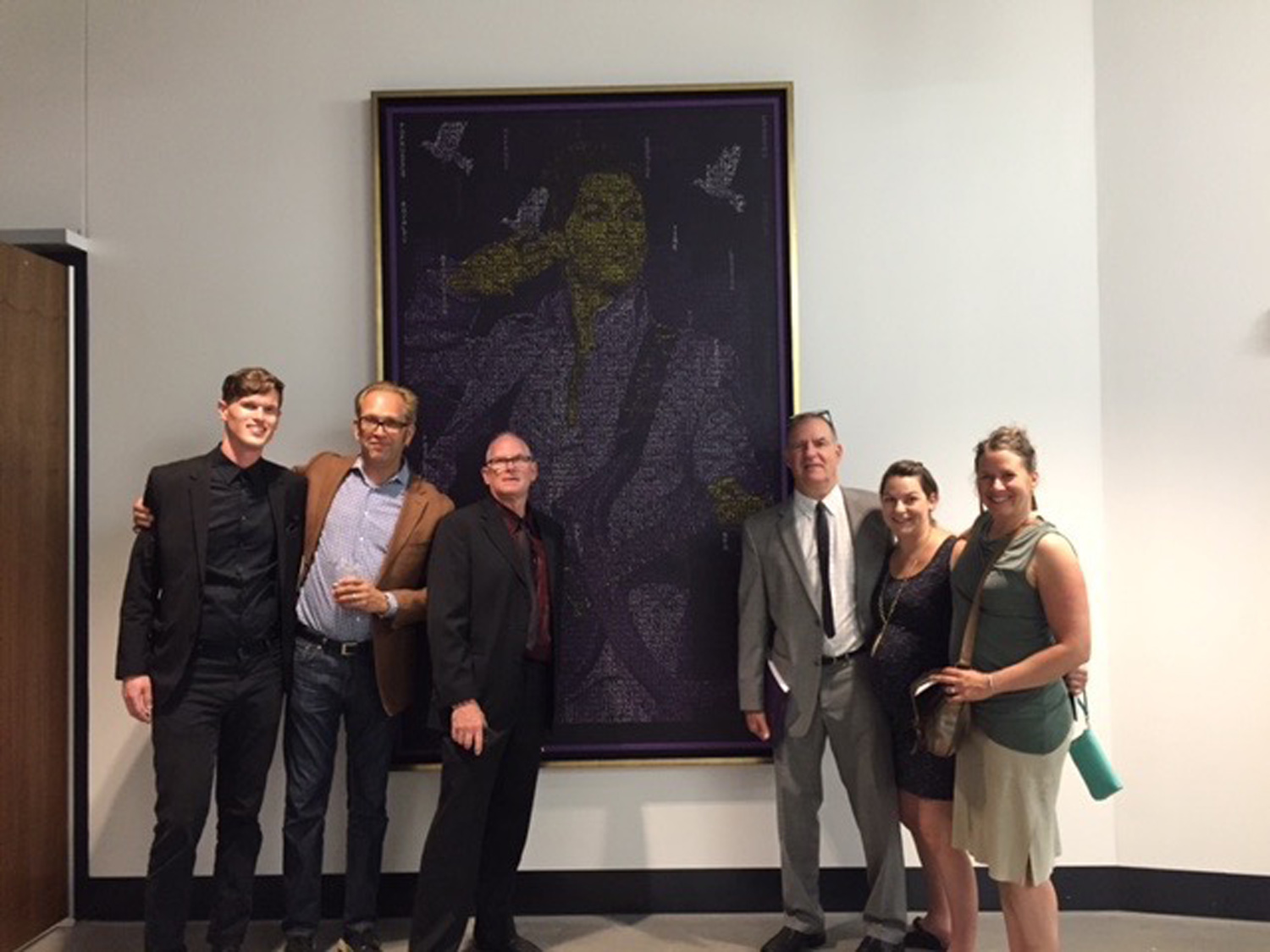  The Hang It crew at the art opening for the US Bank Stadium - standing in front of the Prince piece that we stretched and framed. 