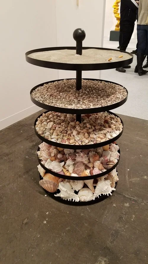 Nicole Wermers, "Shell Ashtray" 2018, Powder coated steel, sand, seashells and cigarettes Courtesy of Jessica Silverman Gallery