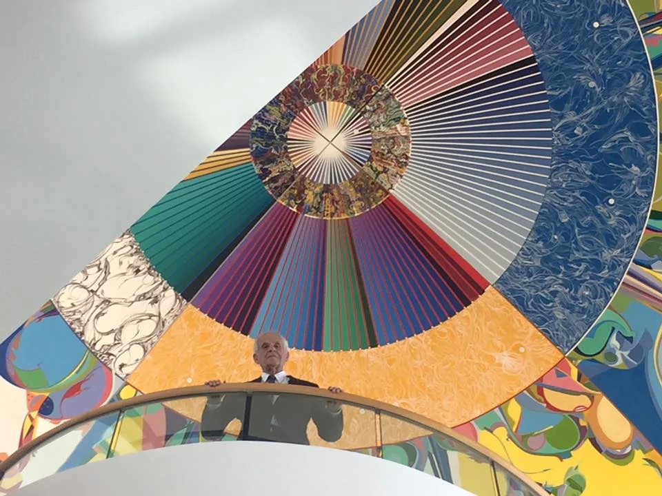 Douglas underneath friend Alex Janvier's painting