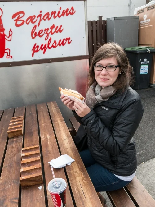 Alison (embarrassed) about to enjoy one of Reykjavik’s famous and cheap hotdogs, 2015.