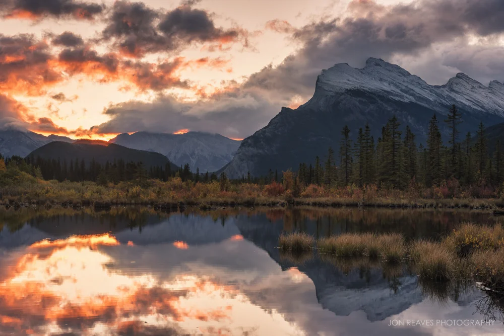 A brief opening in the clouds allows a bit of dramatic light to get through during sunrise, Mount Rundle, Banff National Park