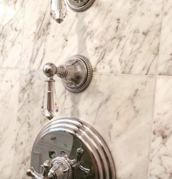 Crystal knobs against marble with a chrome finish