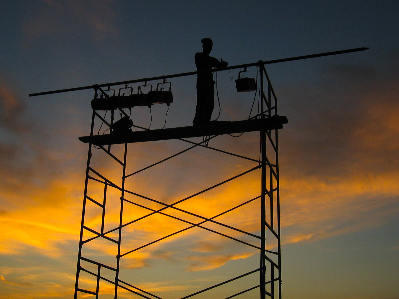 Haiti 2006 2nd day sunrise worker on scaffold.jpg