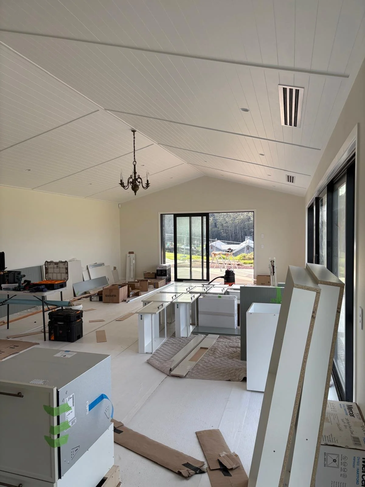 Raking ceiling and open-plan living area during construction of a Maddren Homes home in Weiti Bay