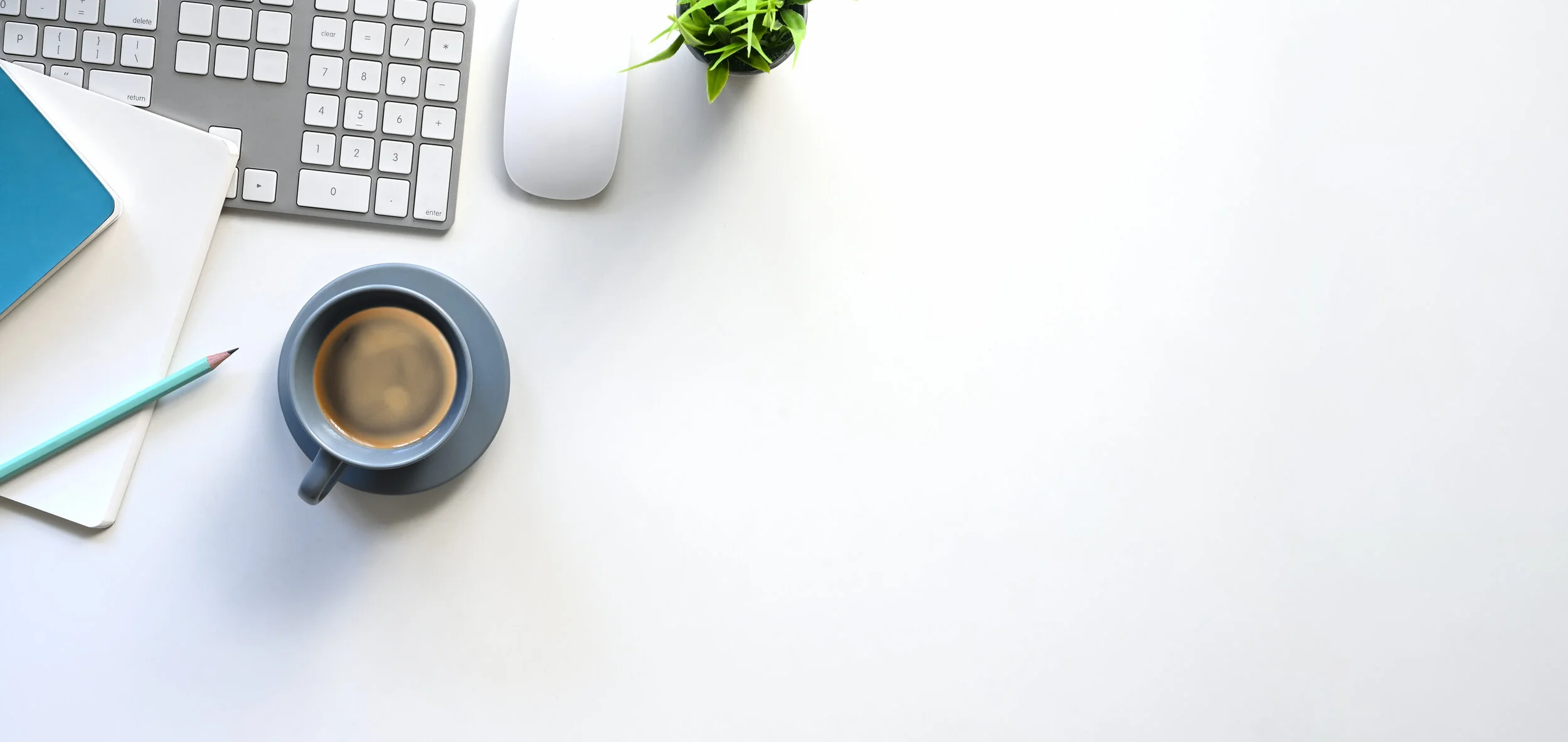 work space with coffee, white and blue notebooks.jpeg