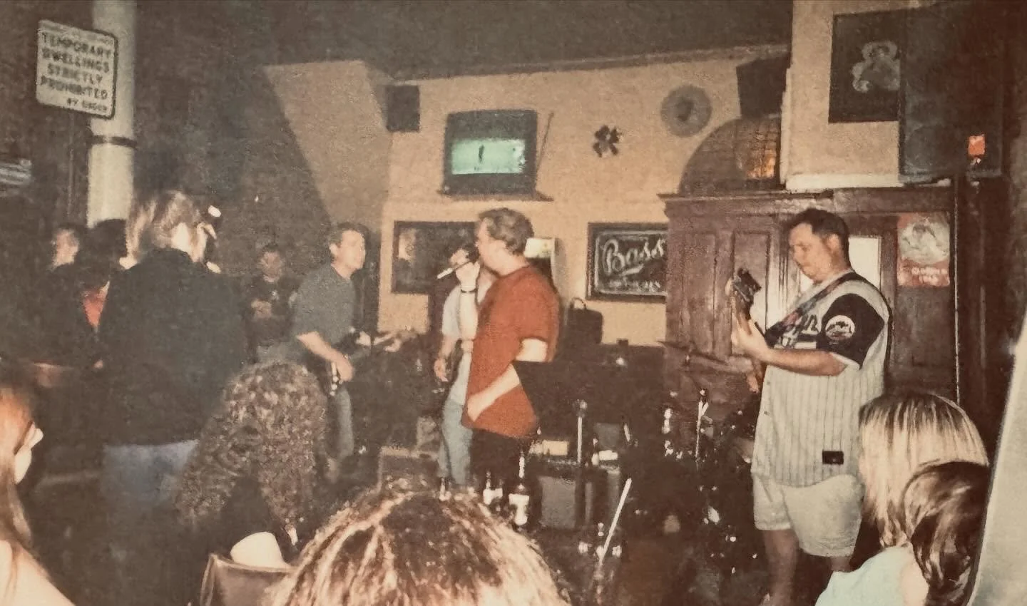 It’s throwback Thursday and we’ll go back to the vault for these photos taken on 6-14-2002. It was the first show with Keith as an official member of the band.  A lively show in Three Jolly Pigeon’s, Bay Ridge Brooklyn. Were you the