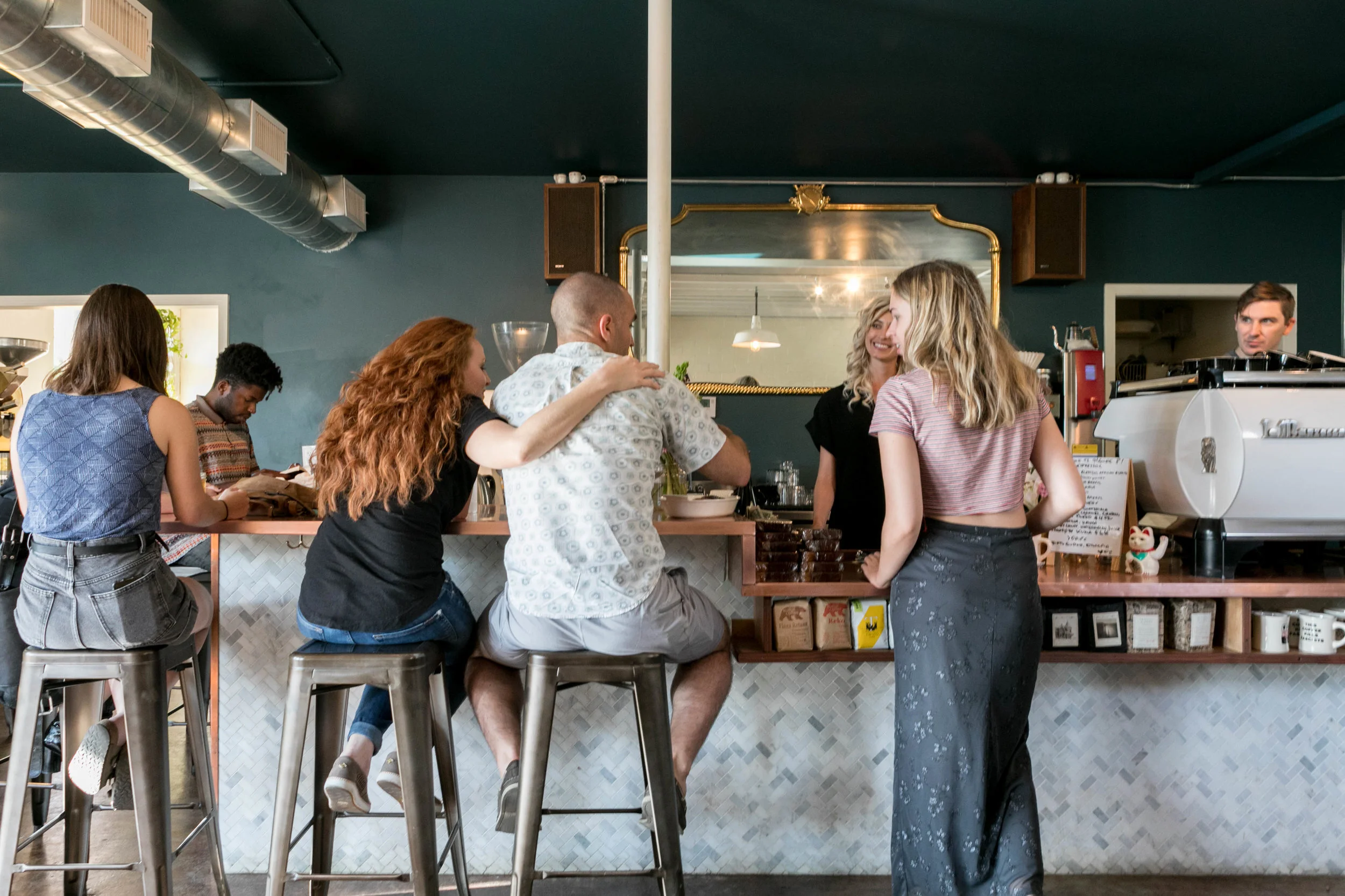 Customers sitting at the coffee bar counter at Figure 8 Coffee Purveyors in East Austin, Texas