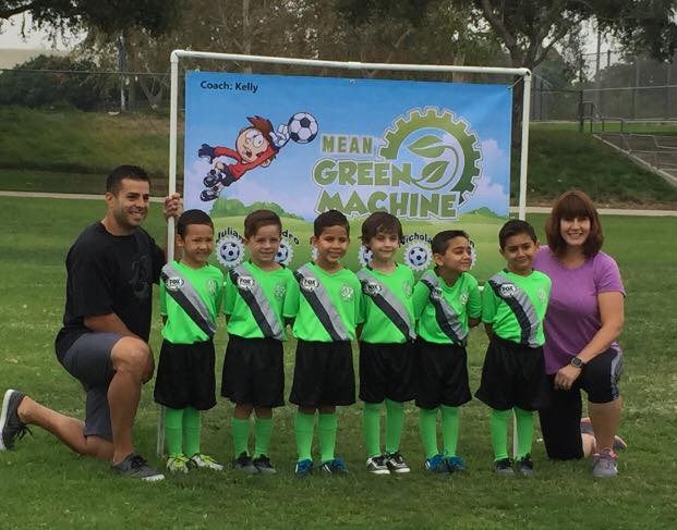 Coach Kelly with the Mean Green Machine (her son Kevin is the fourth child from the left) in September 2016