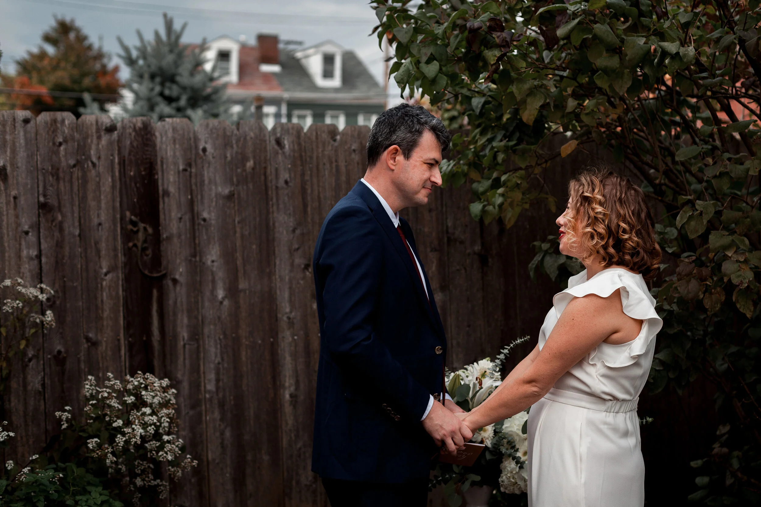 Bride and groom holding hands during ceremony.