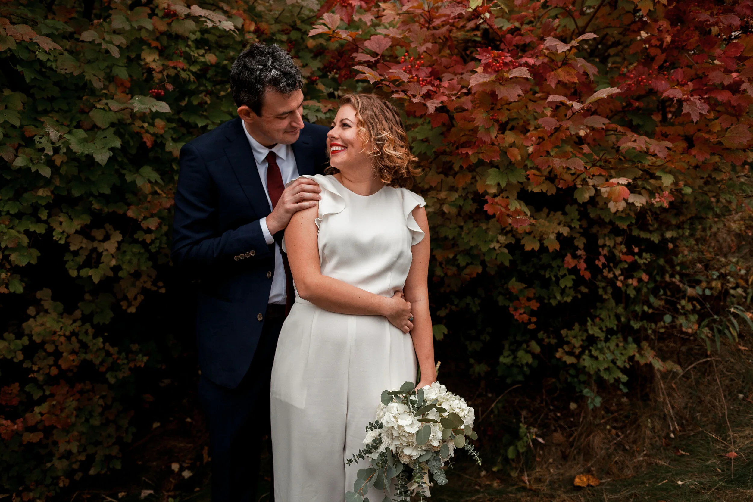 Couple laughing with fall leaves in Pittsburgh.