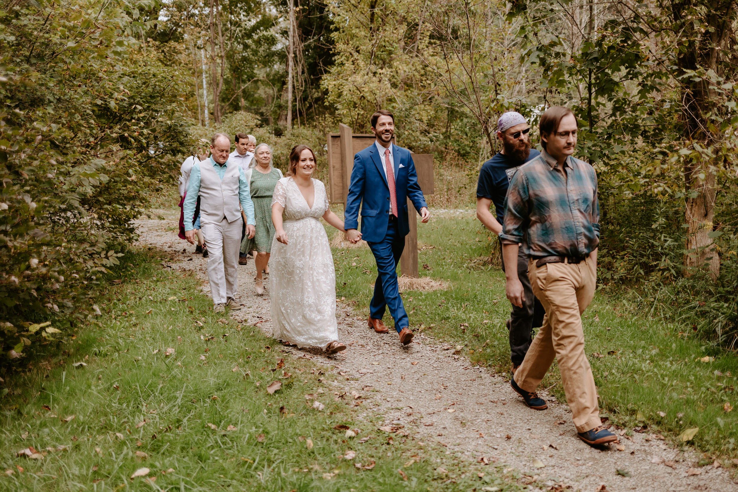 Couple and their families walk on trail for their elopement day.