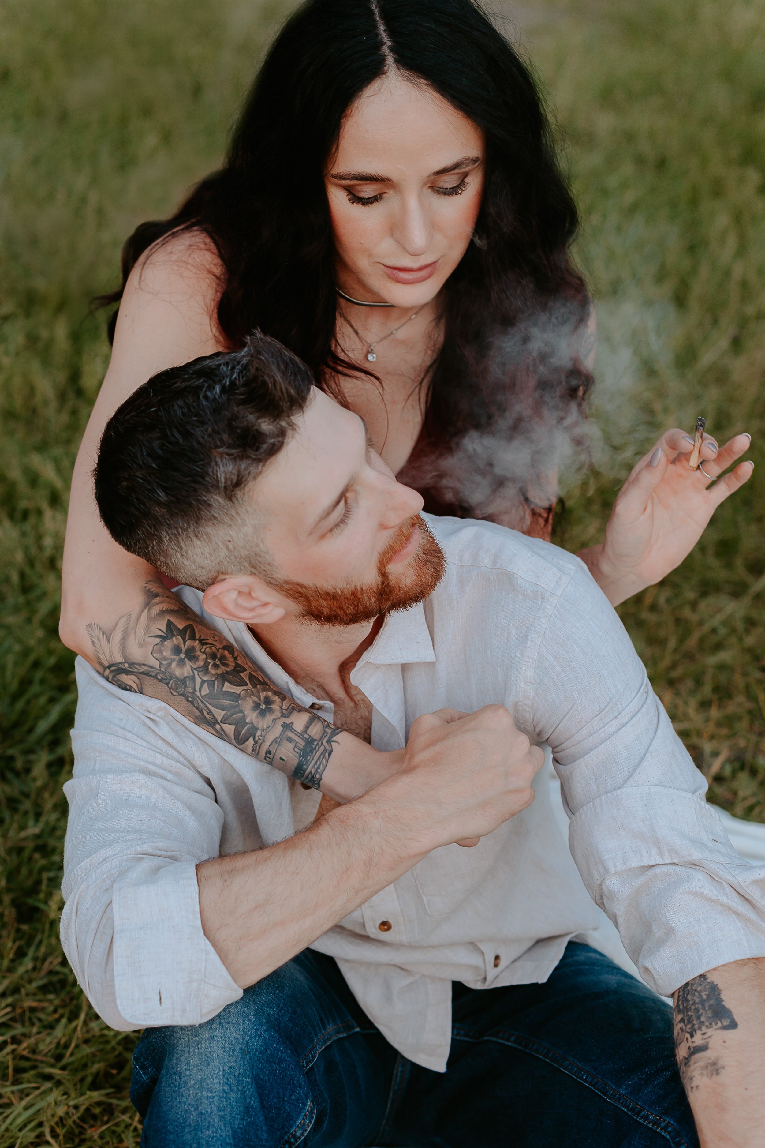 Woman and man smoke a joint together.
