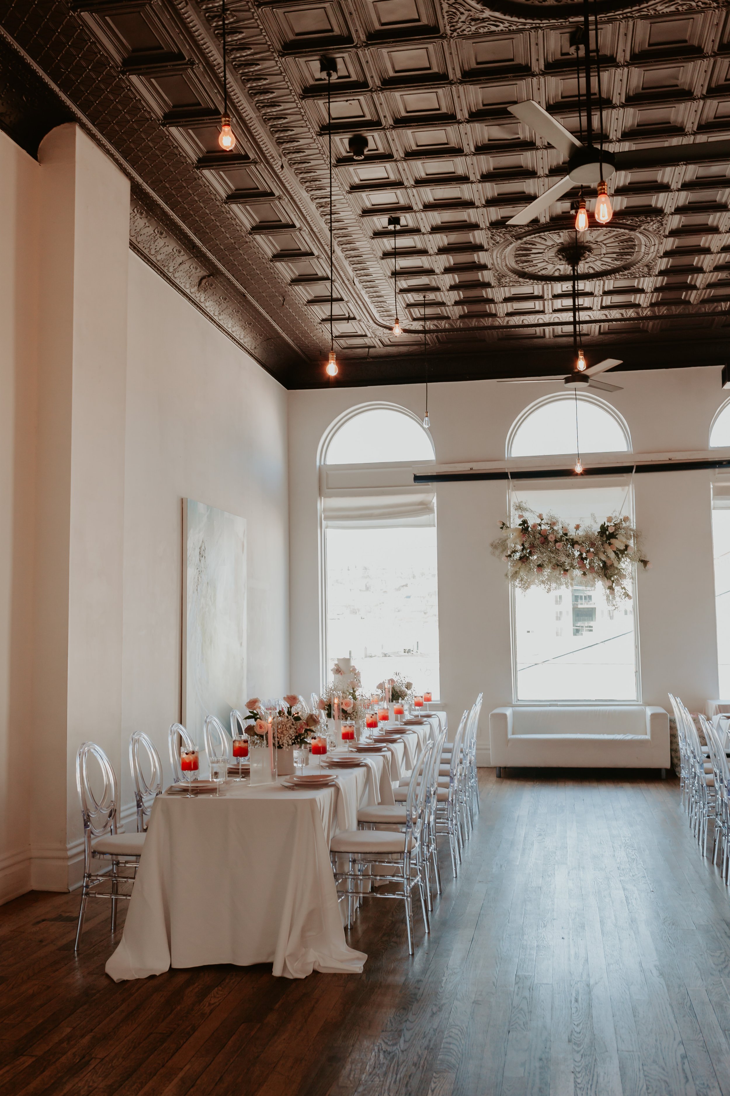 Bright wedding reception space with white linens.