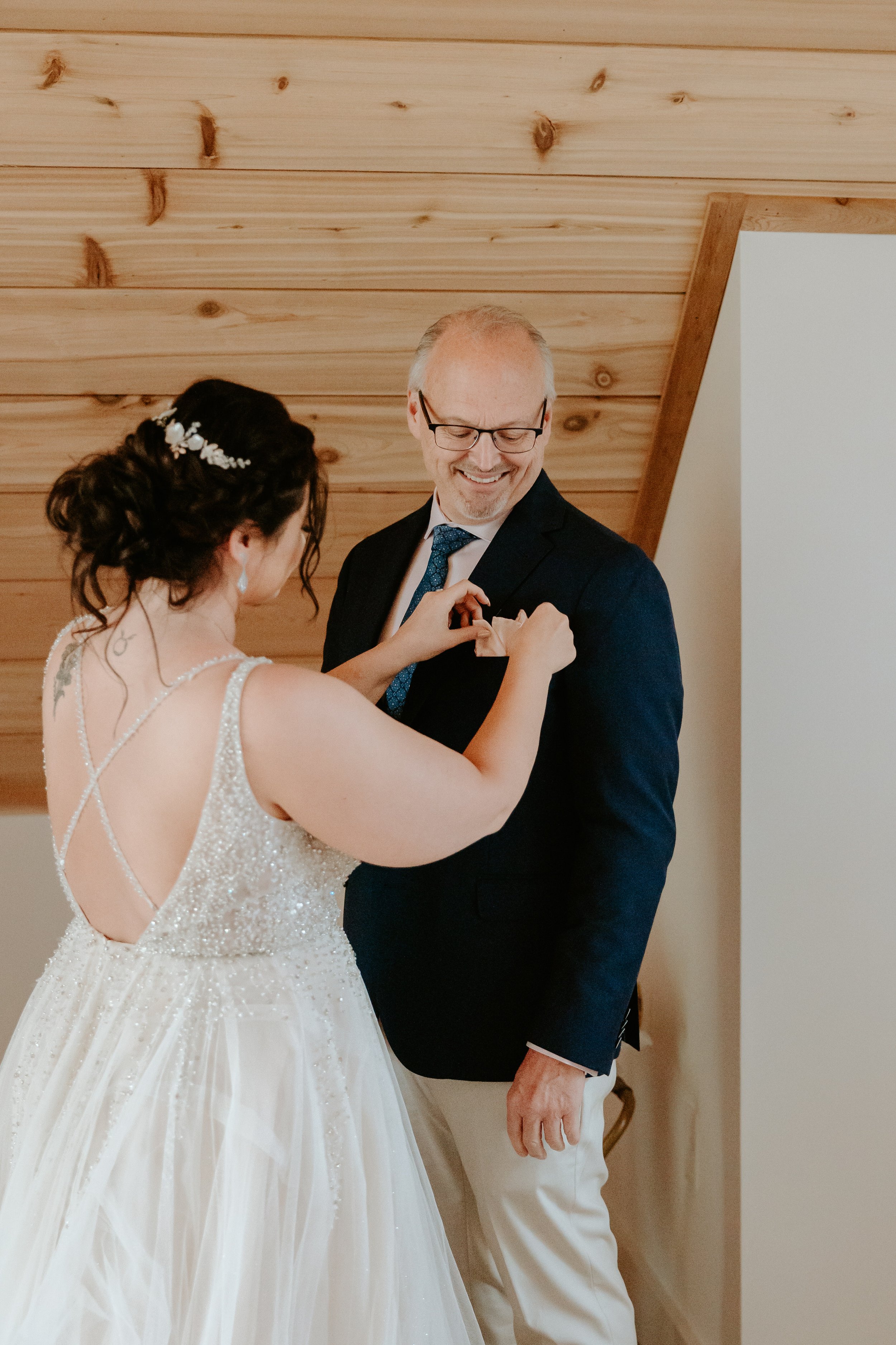 Woman fixes her dad's pocket square.