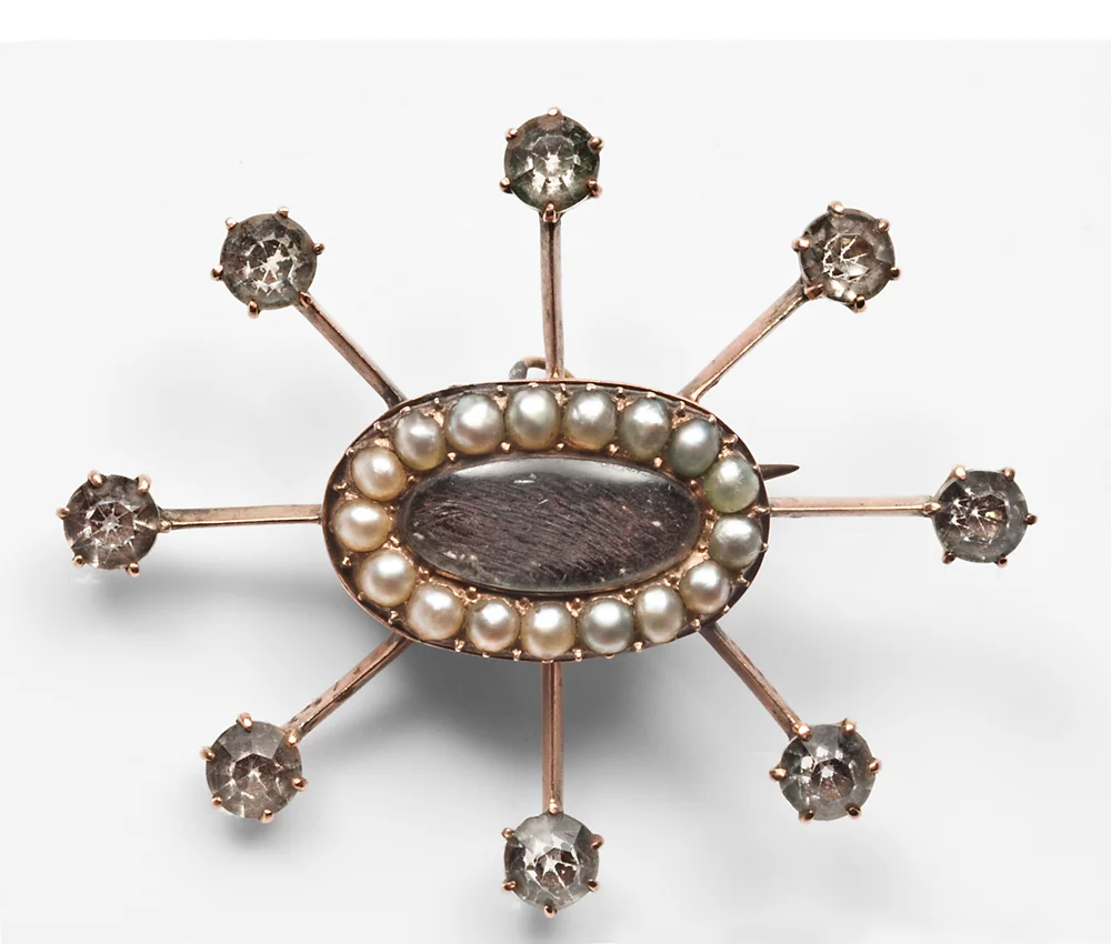 Above: Paste diamonds add drama to a pearl and hairwork brooch c.1820.