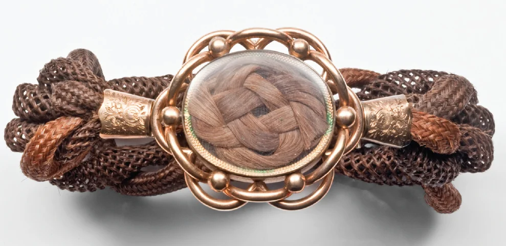 Left: This elaborate sentimental hairwork bracelet dated 1858 combines the hair of seven family members