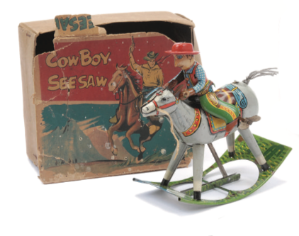 A rare 1950s novelty ‘Cowboy See-Saw’ made by C K Toys. A clockwork motor makes the horse rock back and forth, and the cowboy has a hinged arm so it appears that he's firing his gun. Sold for £96 in August 2014
