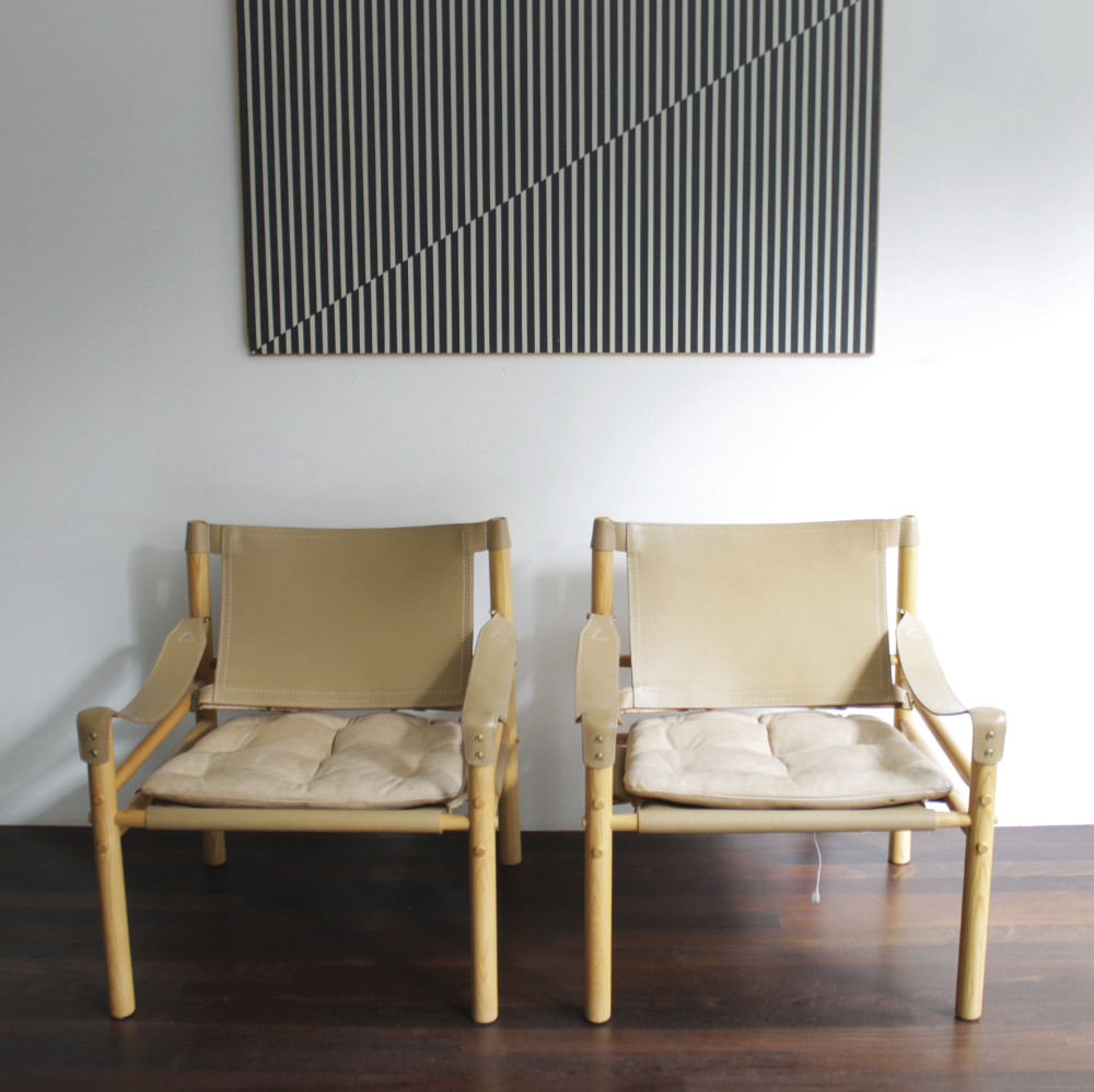 SIROCCO: Made in 1964 and inspired by the Danish Kaare Klint’s Safari leather chairs (which in turn took inspiration from an English campaign chair Klint had seen in an African picture!) As with original campaign furniture, it can be easily disassembled if needs be. Note the stringing to the base that holds the sling seat in position, supporting a loose cushion (below).