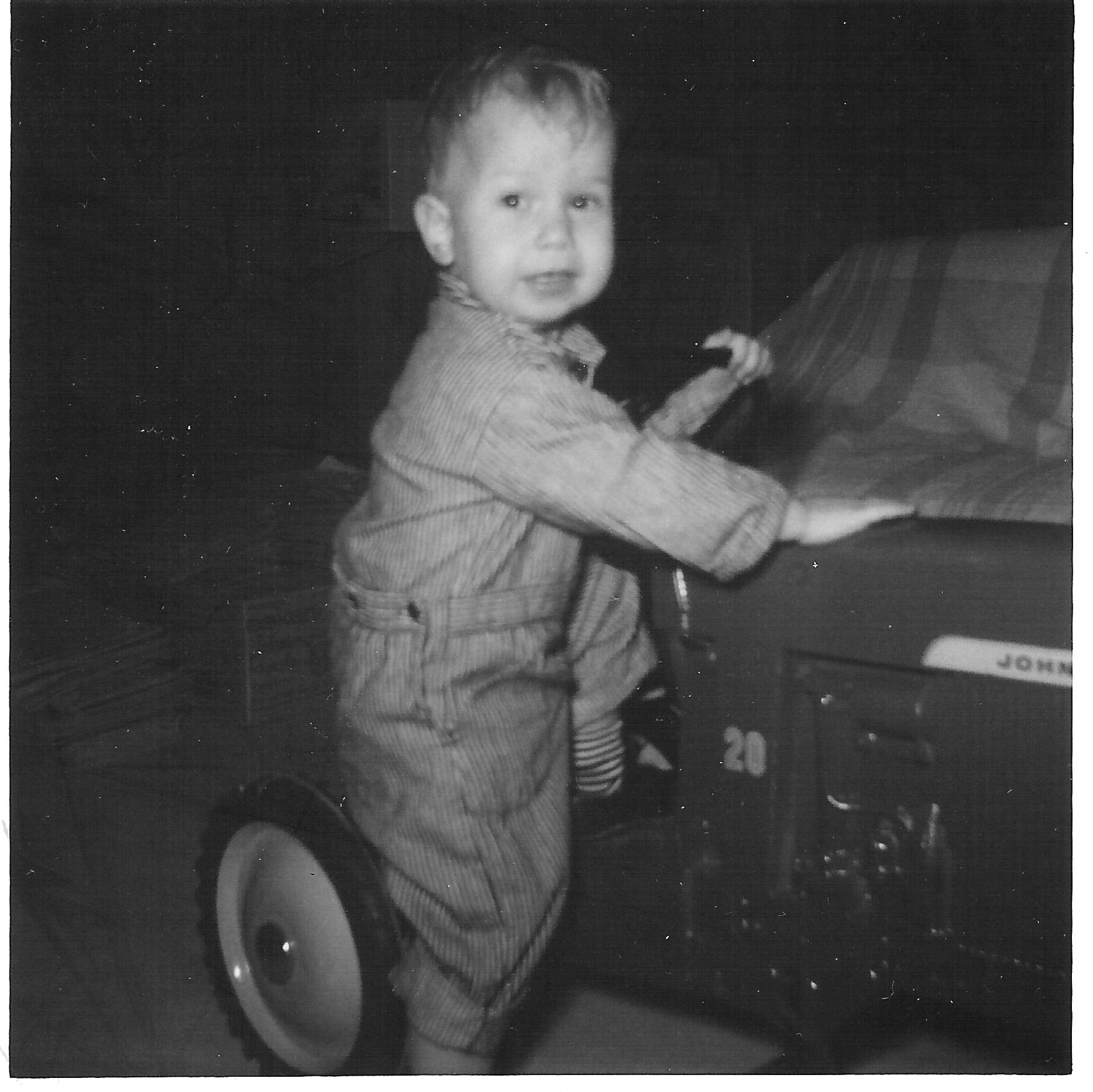 All dressed up and ready to ride my John Deere pedal tractor in the late 1960s.