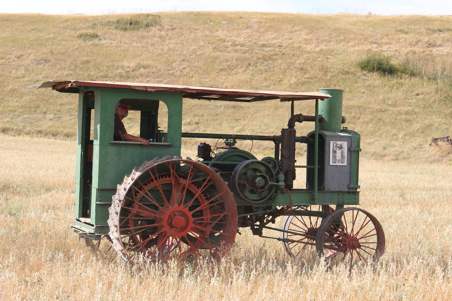 This shot of an old Case being driven through the grass is reminiscent of the old days when Prairie tractors roamed the fields. Photo Luke Steinberger