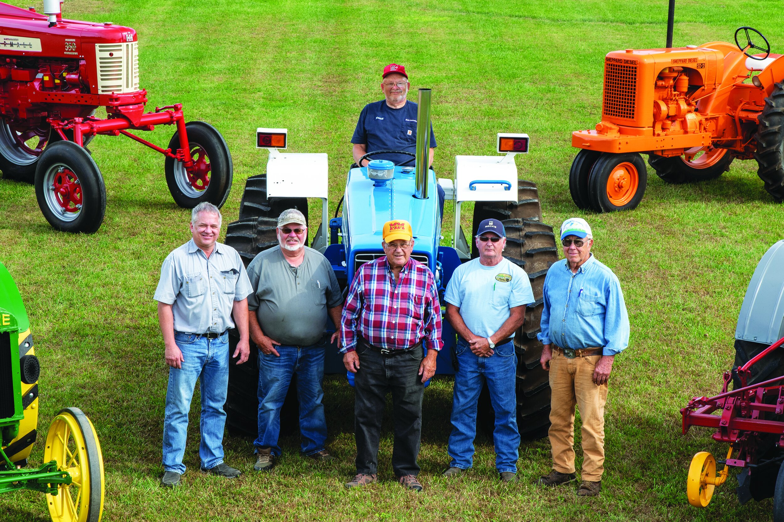  The tractor crew on “picture day” included, from left to right, Ron Poeppelman, Bob Rhoades, John Berger, Nelson Ashbaugh, and Don Marchal. Wendell Kelch is on the tractor. 