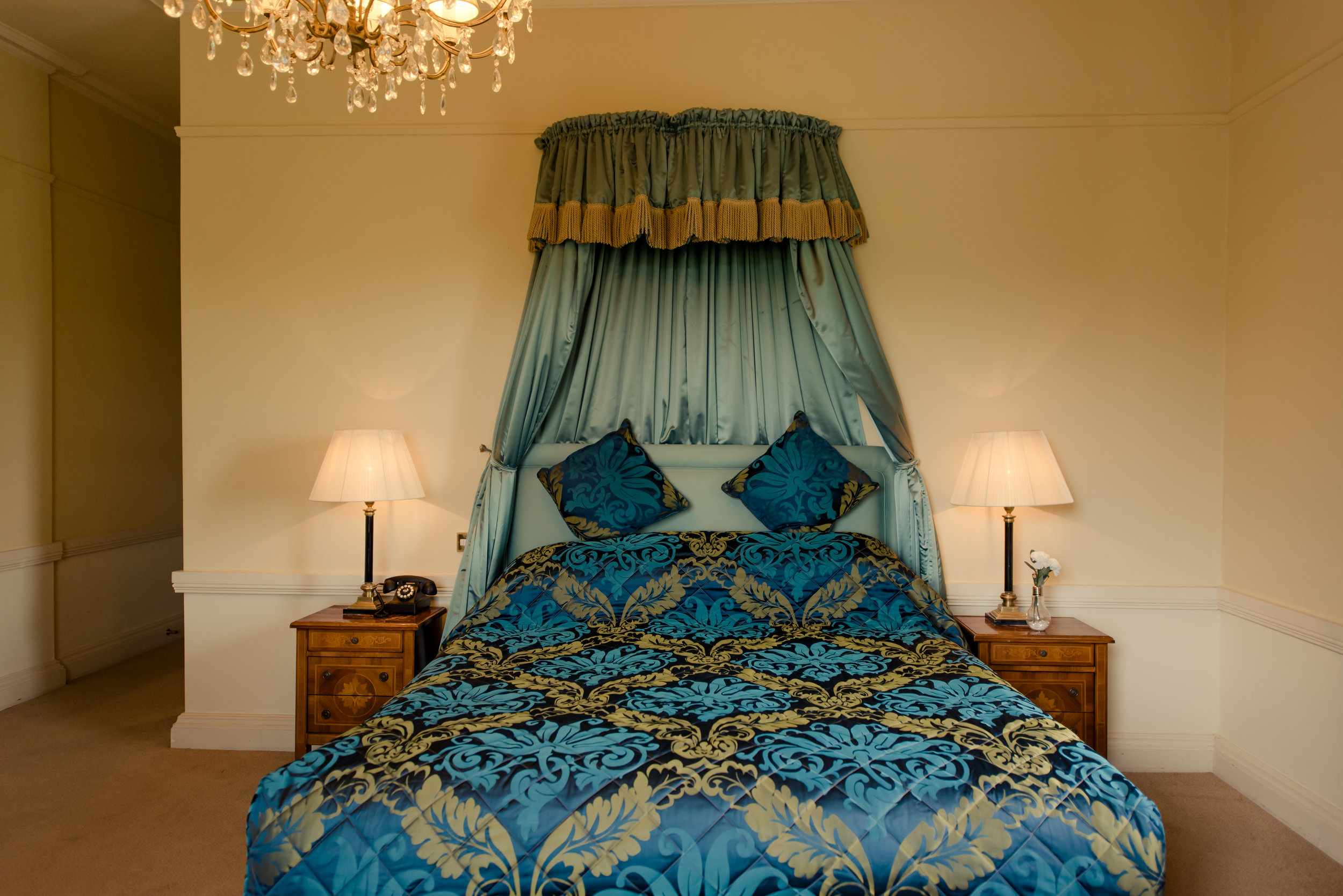 Tulfarris Hotel & Golf Resort Manor House bedroom with bedside lockers and lamps.jpg